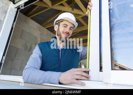 happy man measuring a window Stock Photo
