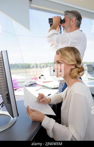 air traffic controllers at work in the flight control tower Stock Photo
