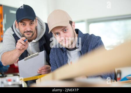 two wood designer working in workshop Stock Photo