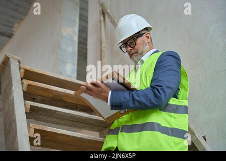 Portrait of male foreman in protective helmet at construction site Stock Photo
