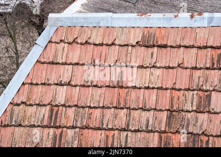 Closeup surface of old weathered ceramic tiles covering building roof Stock Photo