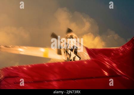 Photo illustration of a red-tailed P-51 Mustang like those used by the Tuskegee Airmen in flight. Stock Photo