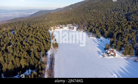 Golcuk Nature Park in Bolu, Turkey. Beautiful winter landscape at Golcuk Lake. Aerial view of mountain house and forest. Stock Photo