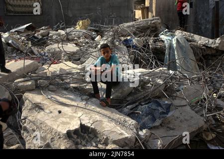 A palestinian boy sitting on his destroyed house by Israeli air strikes in Rafah in the southern Gaza Strip on Tuesday on August 9, 2022. An Egypt-brokered ceasefire reached late on August 7 ended the intense fighting that killed 46 people including 16 children and wounded 360 in the enclave, according to Gaza's. Photo by Ismael Mohamad/UPI Credit: UPI/Alamy Live News Stock Photo