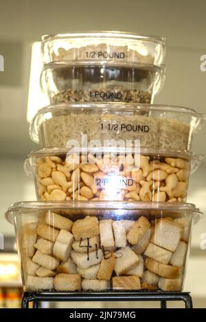 Stacked plastic to go containers holding assorted dry ingredients with different measurements written on them to demonstrate how much they will hold Stock Photo