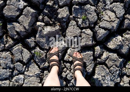 9 August 2022 - London, UK, Ornamental Water pond in Wanstead Park dried up due to the heatwaves and high temeratures in the city, feen on dry cracked soil Stock Photo