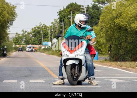 BANGKOK, THAILAND, APR 29 2022, A motorcyclist is standing at an intersection Stock Photo