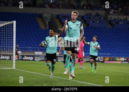 Cardiff, UK. 09th Aug, 2022. Joe Piggott of Portsmouth (10) celebrates with teammates after he scores their 1st goal. EFL Carabao cup round 1 match, Cardiff city v Portsmouth at the Cardiff City Stadium in Cardiff, Wales on Tuesday 9th August 2022. this image may only be used for Editorial purposes. Editorial use only, license required for commercial use. No use in betting, games or a single club/league/player publications. pic by Andrew Orchard/Andrew Orchard sports photography/Alamy Live news Credit: Andrew Orchard sports photography/Alamy Live News Stock Photo