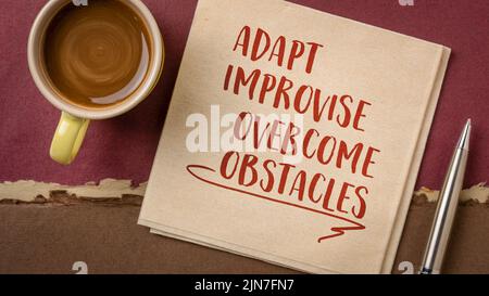 adapt, improvise, overcome obstacles - motivational note or advice on a napkin, challenge and personal development concept Stock Photo