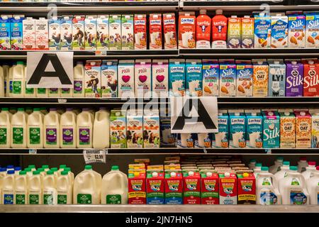 Containers of milk in a supermarket refrigerator in New York Stock Photo -  Alamy