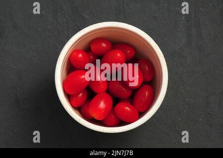 Bowl of baby plum tomatoes Stock Photo