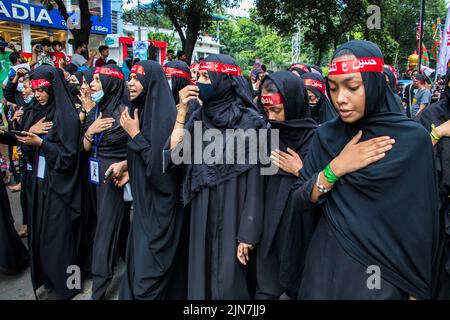 Bangladeshi Shia Muslims march and carry the flags and Tazia during a ...