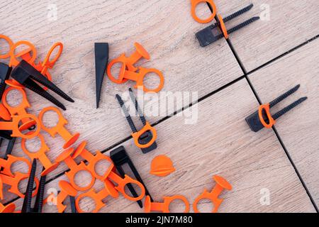 Tile leveling system with plastic clips and wedges. repair school Stock Photo