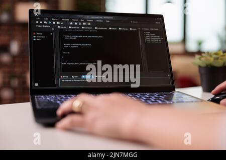 App developer using terminal window with code, developing new user interface on programming html software. Coding firewall security with online cloud app on laptop, IT development. Close up. Stock Photo