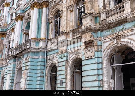 Damaged architectural monument of the city of  Kharkiv, broken windows and damaged facade of the building are visible due to Russian shelling in Kharkiv. Stock Photo
