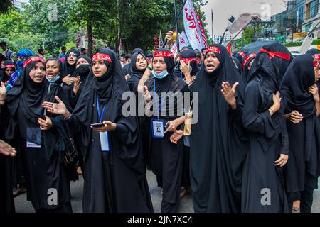 Bangladesh. 9th Aug, 2022. Bangladeshi Shia Muslims march and carry the flags and Tazia during a Muharram procession on the main road in Dhaka. Muharram is respected and observed by Shia Muslims as the month in which Hussein ibn Ali was martyred, the grandson of Muhammad and son of Ali, in the Battle of Karbala. (Credit Image: © Md. Noor Hossain/Pacific Press via ZUMA Press Wire) Stock Photo