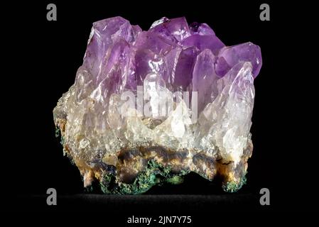 Close up of a chunk of Amethyst, a type of purple quartz, on black background. Stock Photo