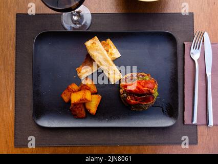 Hamburger with cutlet, pepper, ham, potatoes and white bread Stock Photo