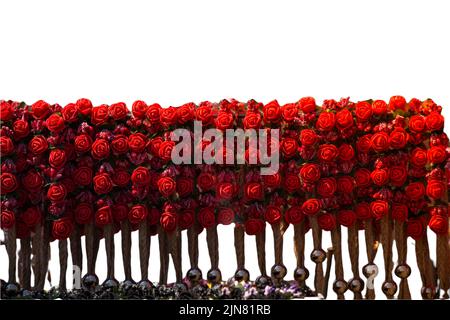 There are fake textile flowers on the crown. Colorful isolated crowns for sale made of fake flowers Stock Photo