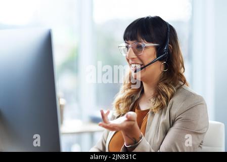 You have two options here, sir. an attractive young businesswoman sitting and using a headset in her office during the day. Stock Photo