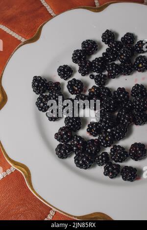 wild picked Blackberries on white plate Stock Photo