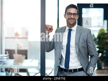 The boss is ready to see you now. Portrait of a well-dressed businessman standing in his office. Stock Photo