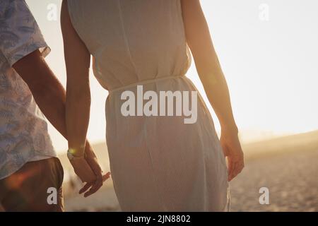 Hands and hearts intertwined on this day. an unrecognizable couple holding hands. Stock Photo