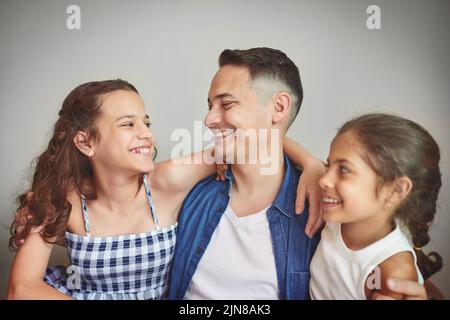 They bring so much joy in to my life. a man spending quality time with his young daughters. Stock Photo