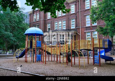 School playground equipment and wood chips on the ground for safety Stock Photo