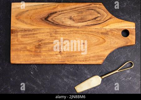 The top view of a rectangular wooden chopping board on the gray surface Stock Photo