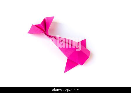 Pink paper fish origami isolated on a blank white background Stock Photo