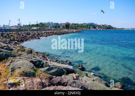 nessebar, bulgaria - sep 2, 2019: old windmill on the embankment at the sea shore. popular travel destination. sunny weather in velvet season Stock Photo