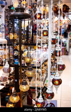 Traditional handmade multicolor Turkish, Moroccan, Arabian lamps. Mosaic style and colored glass lantern. Turkish lamps in souvenir shop in Turkey Stock Photo