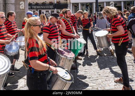 DakaDoum the Afro/Brazilian Percussion Band performing in Penzance town centre on the colourful Mazey Day procession in Cornwall in England in the UK. Stock Photo