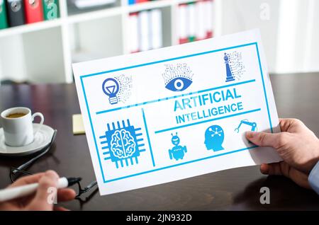 Hand holding a paper showing ai concept Stock Photo