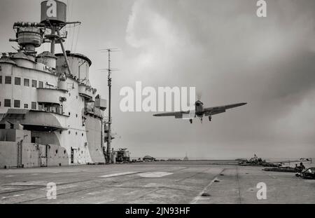 A Hawker Sea Hurricane of 885 Squadron, Fleet Air Arm flying over the flight deck of HMS Victorious prior to landing after flying exercises. The Sea Hurricane IA was a modified Hurricane equipped with catapult spools, an arrester hook and the fourcannon wing. Some 400 aircraft were converted and used on fleet carriers. Stock Photo