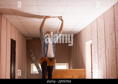 Electrician checking lighting to the ceiling in the home, technician concept Stock Photo