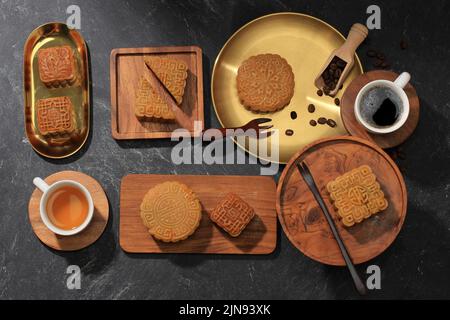 Various Classic Mooncakes with Durian and Salted Egg Yolk Filling, Served with Hot Tea Asian Mid Autumn Festival Stock Photo