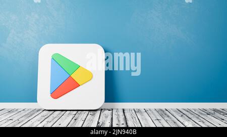 Google Play Store App 2022 Icon on Wooden Floor Against Wall Stock Photo