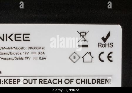 ROHS Restriction of Hazardous Substances, CE symbol logo and recycling information on robotic vacuum cleaner - keep out of reach of children Stock Photo