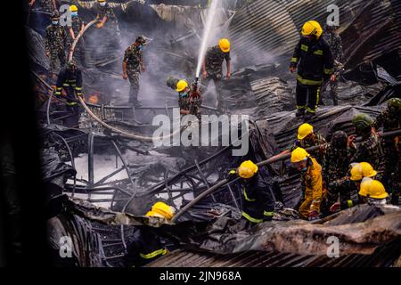 Kathmandu, Nepal. 10th Aug, 2022. Firefighters along with the help of the Army and Police personnel douse a fire that broke out in a shoe factory caused by a short circuit at Balaju, Kathmandu. Credit: SOPA Images Limited/Alamy Live News Stock Photo