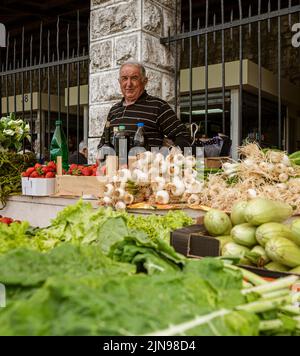 Montenegro - May 7, 2022 - Man sells fruits and vegetables at a stall in the market. Stock Photo