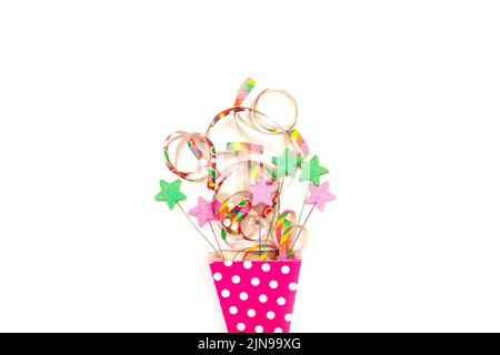 Colored garland and colored stars in a pink with white polka dots bucket on a white background Stock Photo