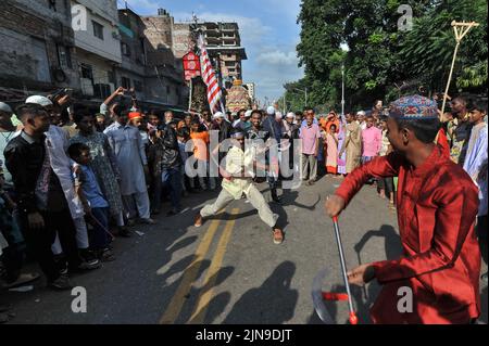 People participate in Ashura traditions in the Bihari Camp in Dhaka, Bangladesh on Aug. 9, 2022.  In the capital Dhaka today, Shia community and Sunnis from Bihari camp observed Ashura with solemn fanfare, which was limited in last 2 years due to lock-down. (Photo by Md Saiful Amin/Pacific Press/Sipa USA) Stock Photo