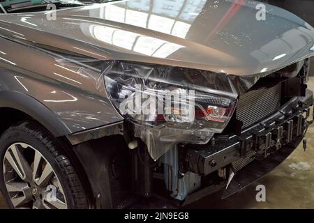 Installation of a protective paint and varnish transparent film on the car. PPF polyurethane film to protect the car paint from stones, marks and scra Stock Photo