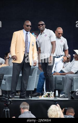 Former San Francisco 49ers players and Hall of Famers defensive end Bryant Young and wide receiver Terrell Owens pose on state during the Pro Football Hall of Fame Enshrinement Ceremony at Tom Benson Stadium in Canton, Ohio, on August 6, 2022. Voters had selected 8 members to enter the PFHOF Class of 2022. Stock Photo