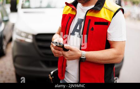 Delivery boy talking on mobile phone with customer while looking for address - concept of customer response, communication home delivery and courier Stock Photo