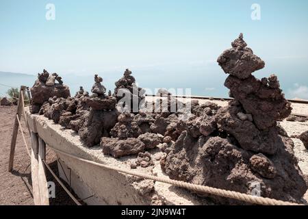 Small piles of volcanic rock made and left  by tourists on the top of Mount Vesuvius Italy. Stock Photo