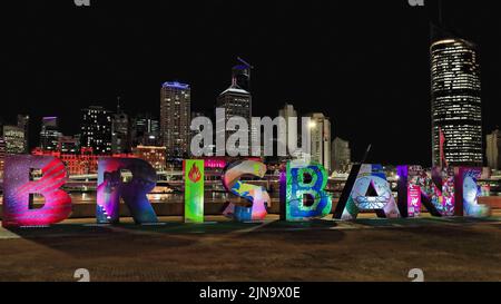 134 Brisbane sign lit up at night with the city CBD skyline in the background. Queensland-Australia. Stock Photo