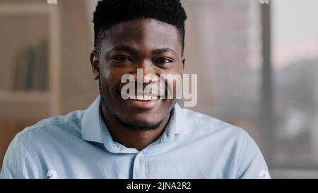 Portrait of successful handsome African American businessman male 30s ethnic boss ceo freelancer customer brunet adult man guy dreaming turns head Stock Photo